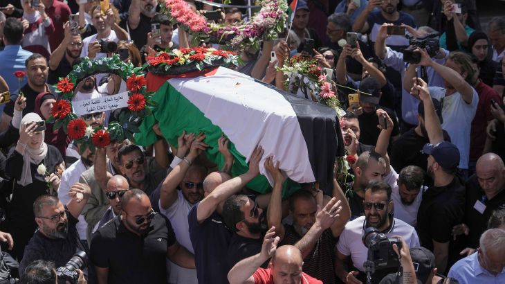 Family, friends and colleagues of slain Al Jazeera journalist Shireen Abu Akleh carry her coffin to a hospital