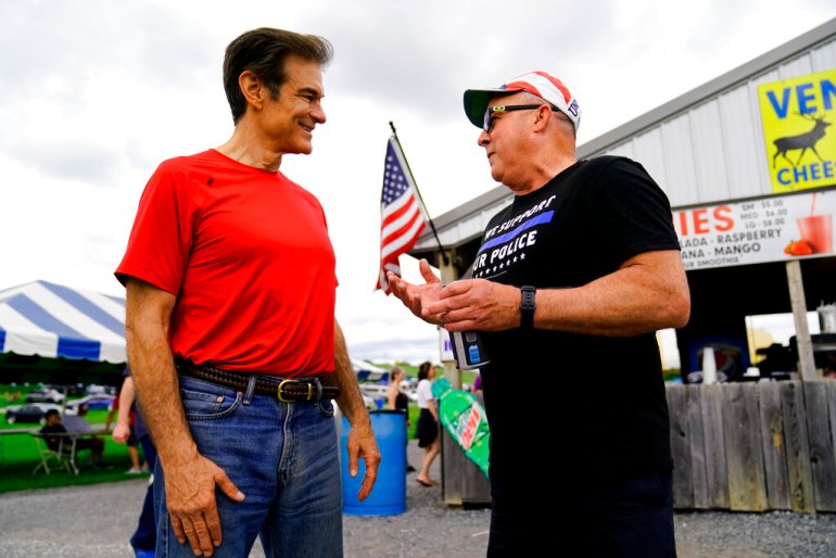 Mehmet Oz, a candidate for the Republican nomination to US Senate in Pennsylvania, meets with a voter during a visit to a car show in Pennsylvania.