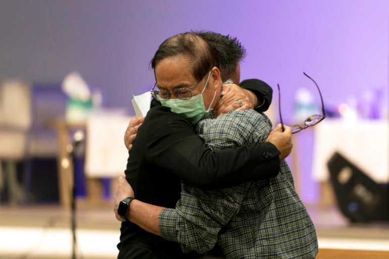 ason Aguilar, left, a senior pastor at Arise Church, comforts Billy Chang, a 67-year-old Taiwanese pastor who survived Sunday's shooting at Geneva Presbyterian Church, during a prayer vigil in Irvine, California.