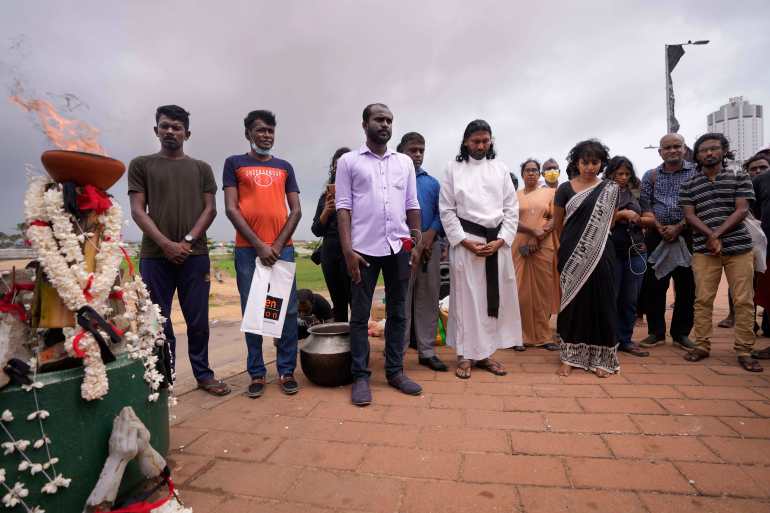 Human rights activists observe a minute of silence in remembrance of victims of Sri Lanka's civil war.