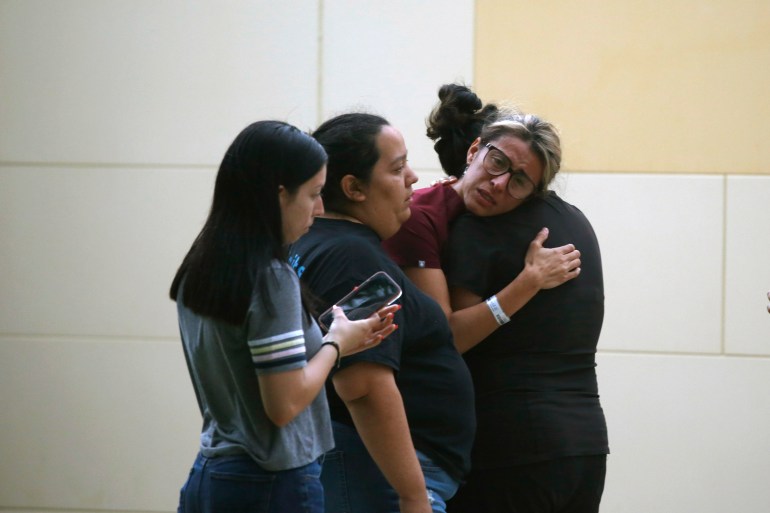 Women console each other after the Ulvade shooting