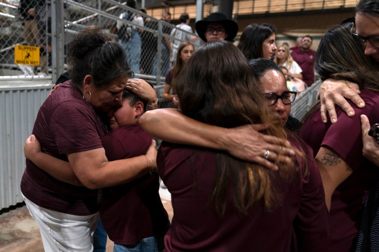 Family members hug each other after their child was killed in the mass shooting at Robb Elementary School