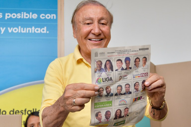 Rodolfo Hernandez, presidential candidate with the Anti-corruption Governors League, shows his ballot before voting in presidential elections in Bucaramanga, Colombia
