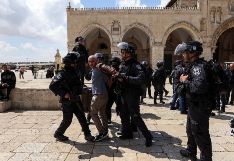 Israeli security forces detain a protester at the compound that houses Al-Aqsa Mosque in Jerusalem's Old City