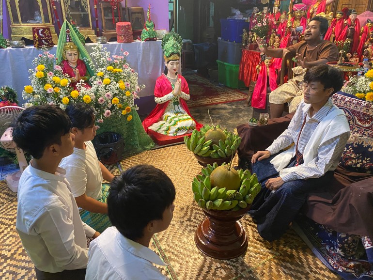 A wizard sits before his disciples in Myanmar