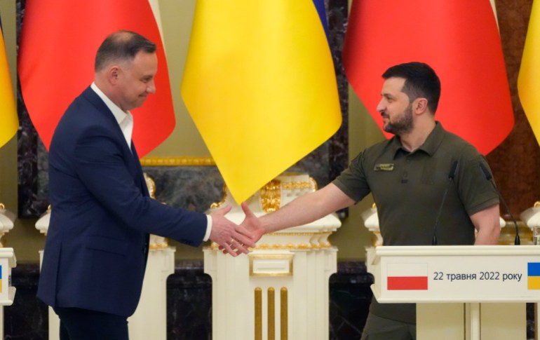 Ukrainian President Volodymyr Zelenskyy, right, and Polish President Andrzej Duda, shake hands during a news conference after their meeting in Kyiv, Ukraine, Sunday, May 22, 2022