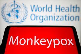 The word Monkeypox is seen on the screen of a smartphone with the World Health Organization (WHO) logo in the background.