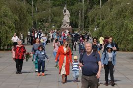 People arrive at the Soviet war memorial in Treptower Park, Germany