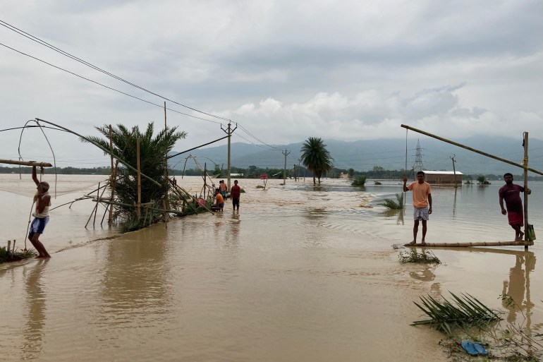 locals fishing in floodwaters in Hojai district