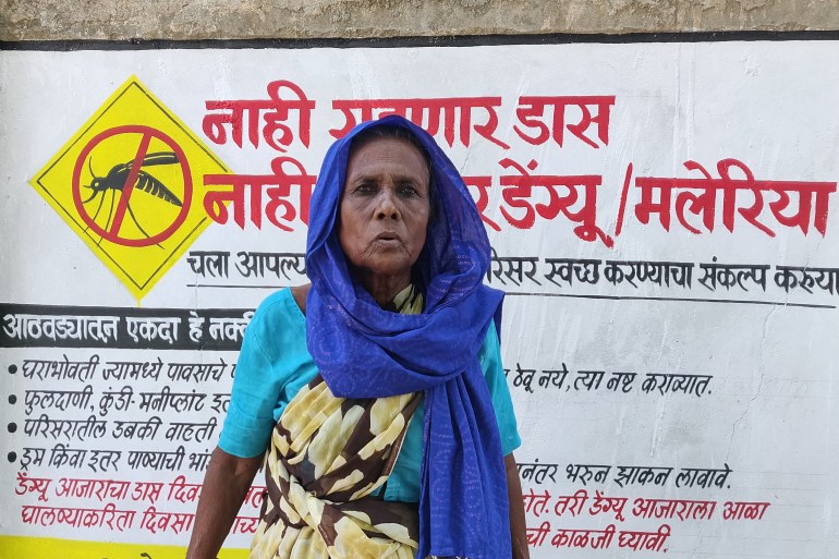 Gokulbai Sahai, whose husband died of air pollution, standing in front of a gov't clinic in Maharashtra, India