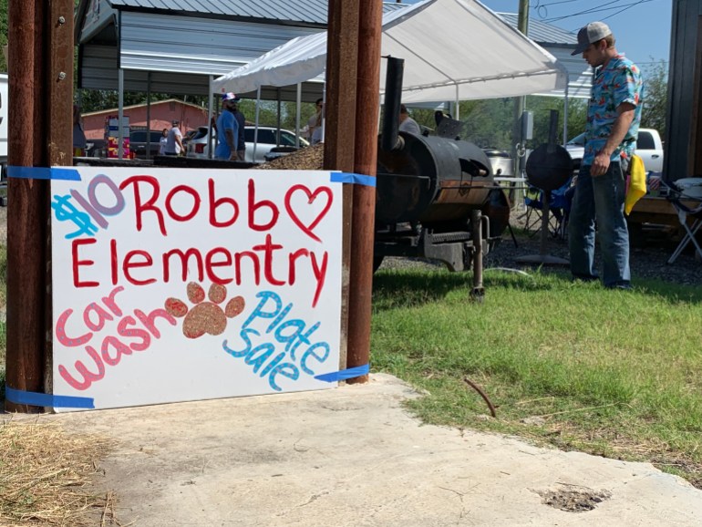 Uvalde residents set up a fundraiser with a big sign for a car wash
