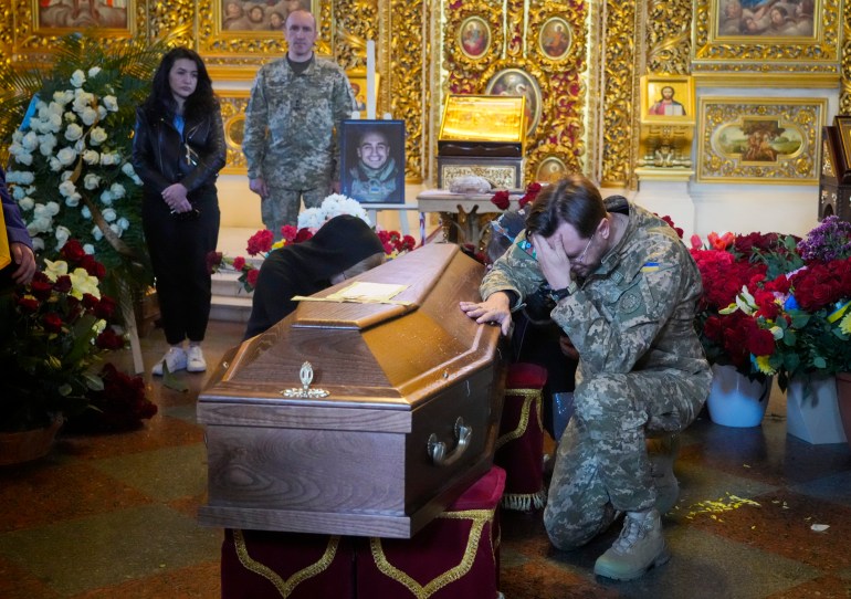 Soldier pays his last tribute to volunteer soldier Oleksandr Makhov, 36 – a well-known Ukrainian journalist killed by Russian troops – during his funeral at St Michael cathedral in Kyiv