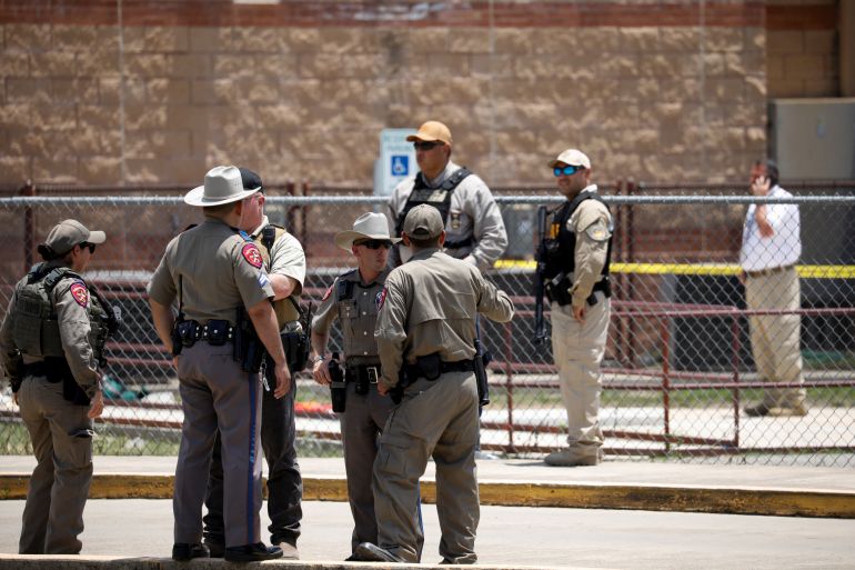 Law enforcement officers guard the scene of a shooting at Robb Elementary School in Uvalde, Texas