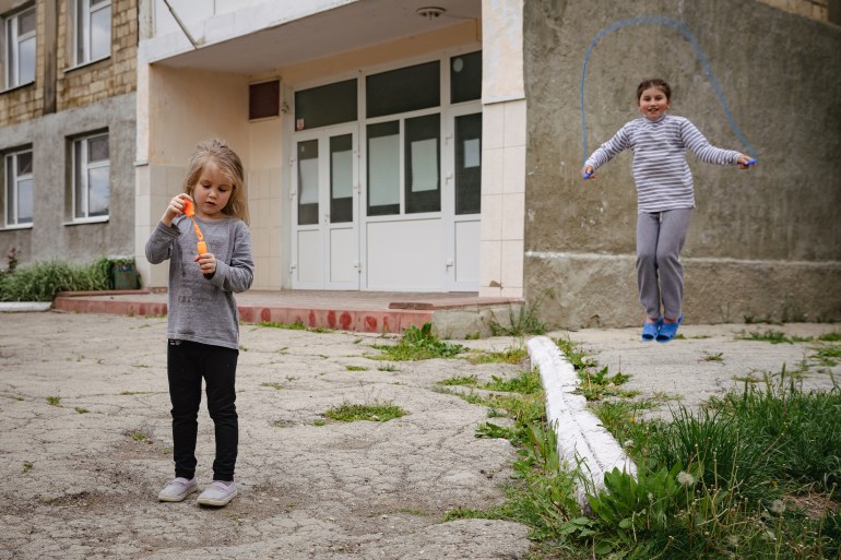 Ukrainian refugees playing in front of their accommodation in Congaz
