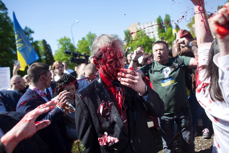 Russian Ambassador to Poland, Sergey Andreev, is covered with red paint in Warsaw