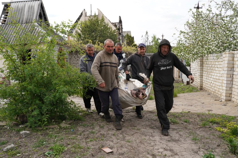 Volunteers exhume the bodies of civilians killed by Russian shelling in the village of Stepaky, close to Kharkiv.