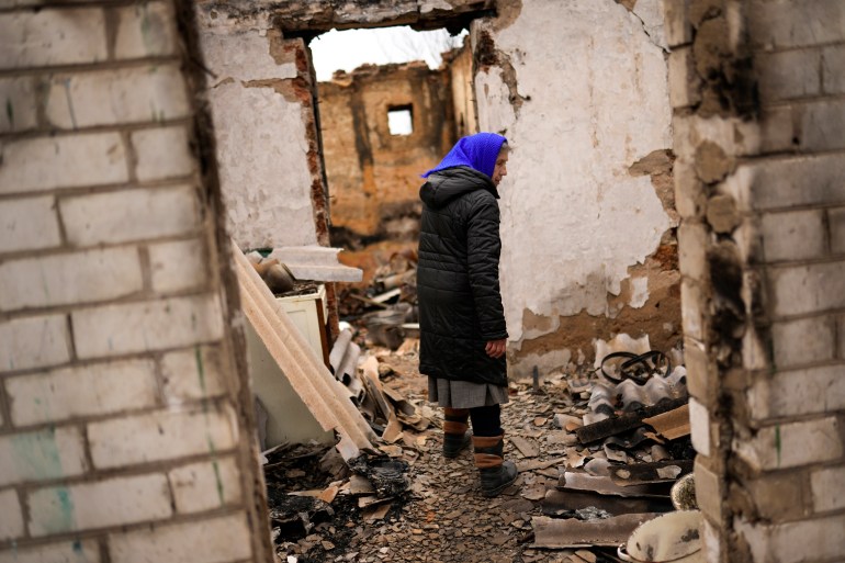 Valentyna Sherba, 68, enters her destroyed father's home in the aftermath of a battle between Russian and Ukrainian troops on the outskirts of Chernihiv.