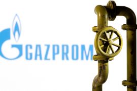 A 3D printed natural gas pipeline is placed in front of displayed Gazprom logo in this illustration