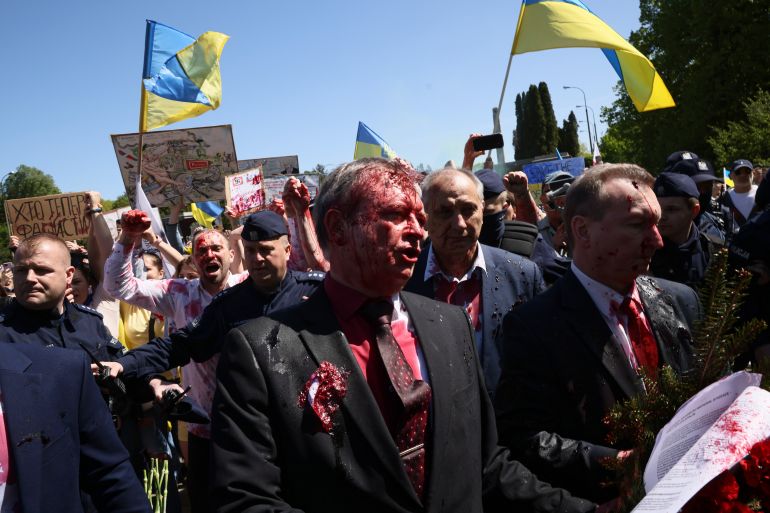 Russian ambassador to Poland, Siergiej Andriejew (C) was doused with red paint