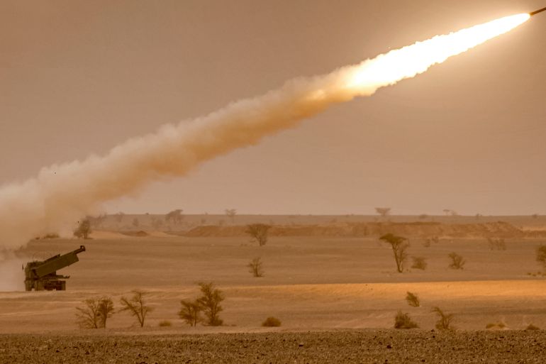 US M142 High Mobility Artillery Rocket System (HIMARS) launchers fire salvoes during a military exercise.