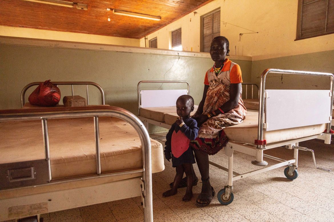 A woman stays with a malnourished child at Kaabong hospital in Kaabong