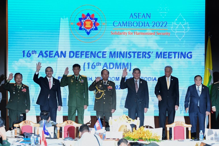 Myanmar's military-appointed defence minister waves alongside his ASEAN counterparts at a meeting this week 