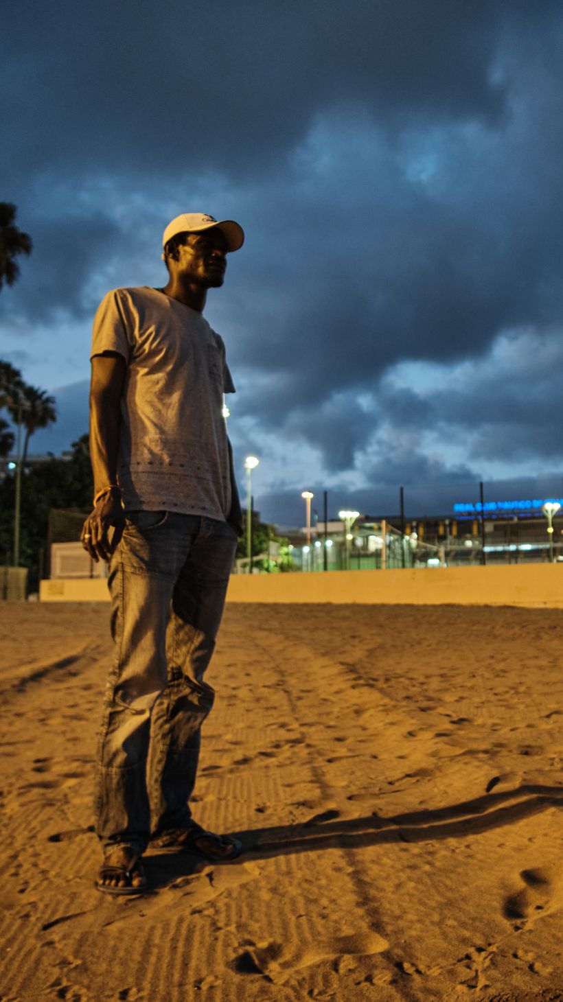 A photo of Ousmane, standing on a beach.