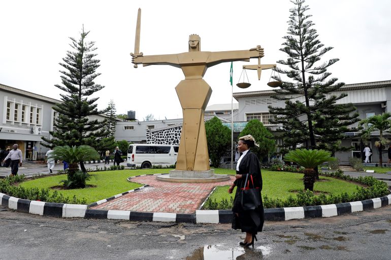 A lawyer walks through the compound at the Federal High Court in Ikoyi district in Lagos, Nigeria