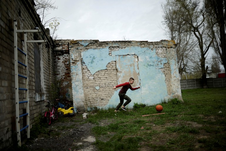 A Ukrainian boy plays at the "Mariupol House of Mothers and Children" shelter, amid Russia's invasion of Ukraine, in the town of Novomoskovsk