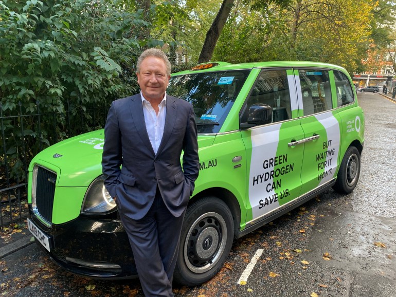 Australian mining magnate Andrew Forrest leaning on a 'green hydrogen' car