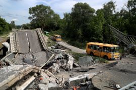 An evacuation convoy travels along a damaged road near Kupiansk on the outskirts of Kharkiv, Ukraine.