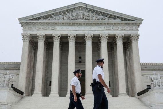 Police officers walk past the US Supreme Court in Washington, DC.