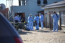 Forensic personnel investigate the deaths of patrons at a tavern in Eastern Cape province of South Africa