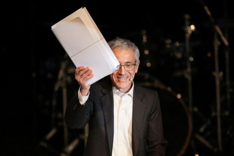 President of the Truth Commission Francisco de Roux holds the report of the Truth Commission.