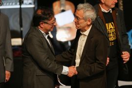 Colombian President-elect Gustavo Petro and Francisco de Roux, President of the Truth Commission shake hands during the presentation of the final report of the Truth Commission