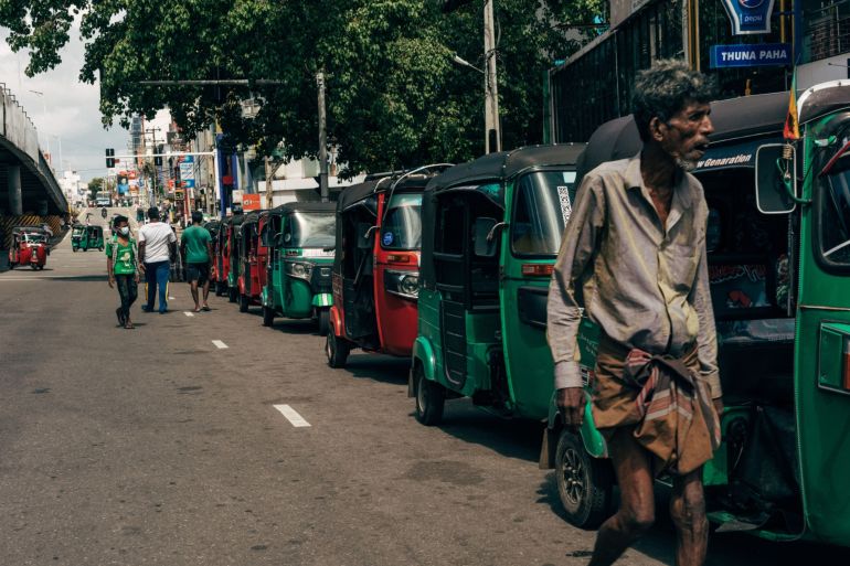 Three-wheeler vehicles queue for petrol in Colombo, Sri Lanka