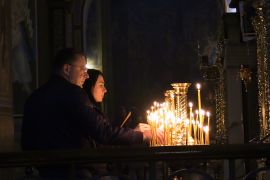 A Ukrainian couple lights candles in St. Michael's Monastery in Kyiv