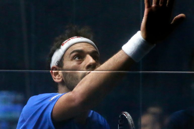 No. 1 seeded player Mohamed Elshorbagy wipes his sweaty hand and arm against the squash court glass wall during a 2017 Windy City Open squash tournament match against Cesar Salazar, from Mexico, at the University Club of Chicago in Chicago [File photo: Charles Rex Arbogast/AP]
