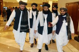 A few members of the Taliban delegation head to the opening session of the peace talks between the Afghan government and the Taliban in Doha on September 12, 2020 [File: AP/Hussein Sayed]