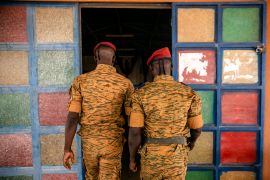 Two soldiers enter the Catholic church at the 10th RCAS army barracks in Kaya, Burkina Faso