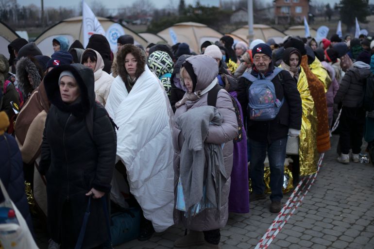Ukrainian refugees waiting in line for transport