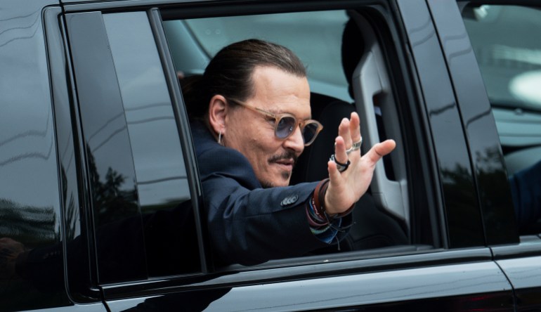 Actor Johnny Depp waves to supporters as he departs the Fairfax County Courthouse Friday, May 27, 2022 in Fairfax, Va. A jury heard closing arguments in Johnny Depp's high-profile libel lawsuit against ex-wife Amber Heard. Lawyers for Johnny Depp and Amber Heard made their closing arguments to a Virginia jury in Depp's civil suit against his ex-wife.(AP Photo/Craig Hudson)