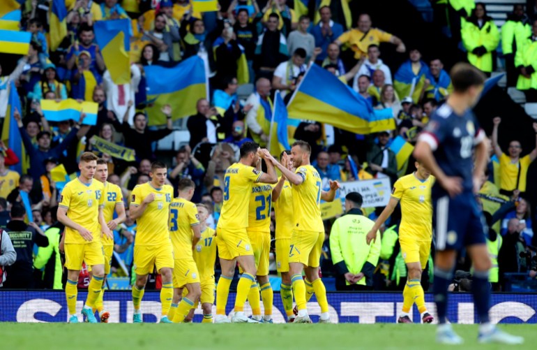 Ukraine's Roman Yaremchuk celebrates with teammates after scoring his side's second goal during the World Cup 2022 qualifying play-off soccer match between Scotland and Ukraine at Hampden Park stadium in Glasgow, Scotland on Wednesday, June 1, 2022 [Scott Heppell/AP]