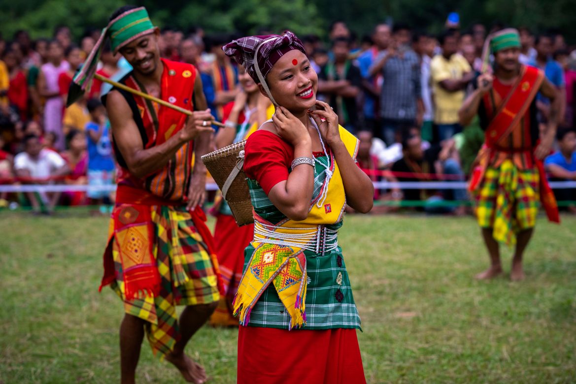 Indian Rabha tribal girls in traditional attire dance during Baikho festival at Gamerimura village
