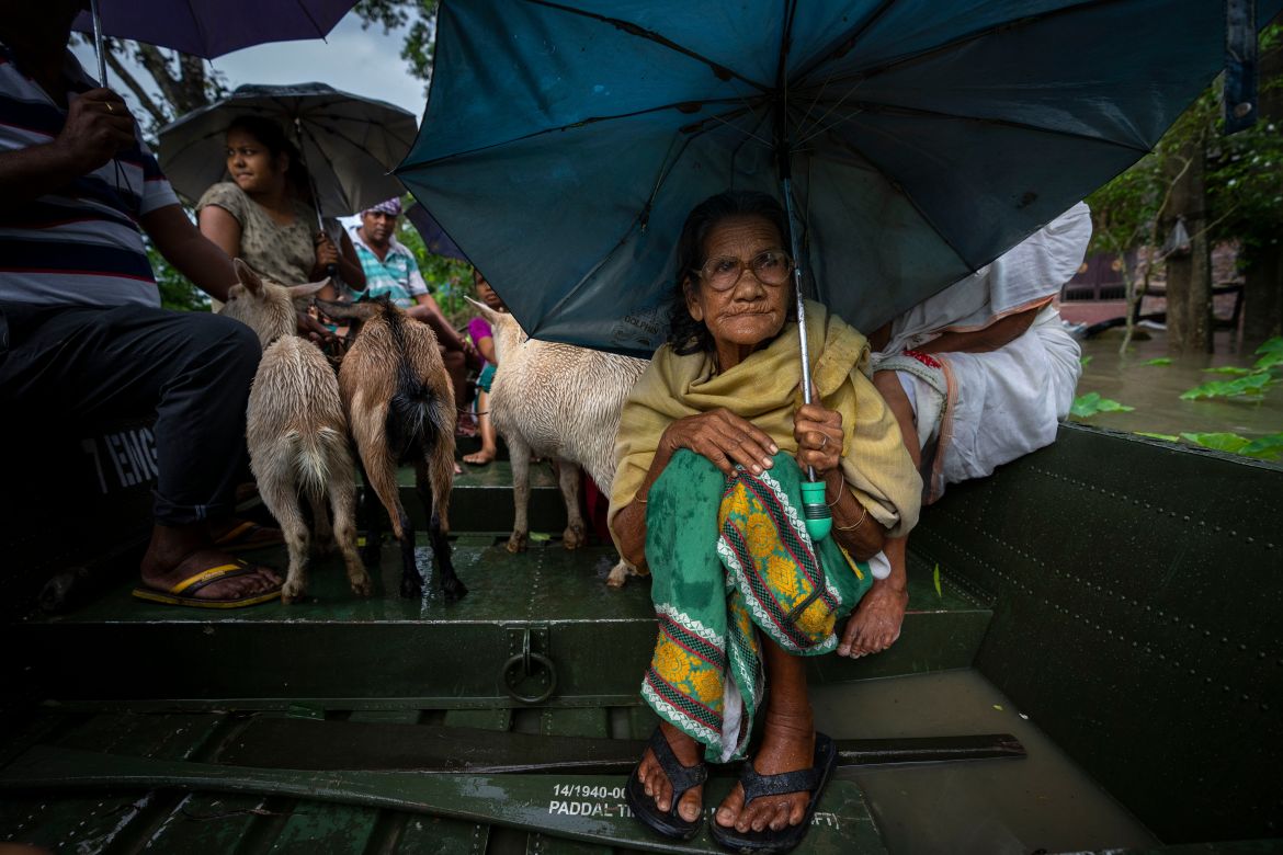 An elderly woman sits on a rescue boat in Jalimura village, west of Gauhati,