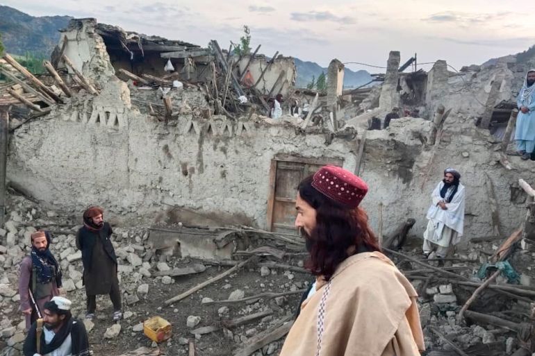 Afghans look at destruction caused by an earthquake in the province of Paktika, eastern Afghanistan