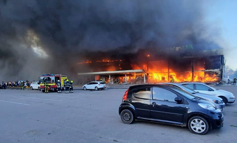 In this image made from video provided by Ukrainian State Emergency Service, firefighters work to extinguish a fire at a shopping center burned after a rocket attack in Kremenchuk, Ukraine, Monday, June 27, 2022