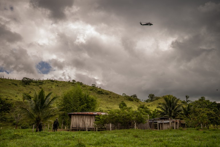 A helicopter flies over a home in Tinigua National Park