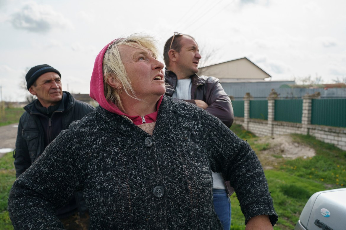 Victor(L), Ivan (R) and Lubov, are watching the missiles that are a few km's away. They had to stay in Shevchenko village because they had nowhere to go due to economical reasons.