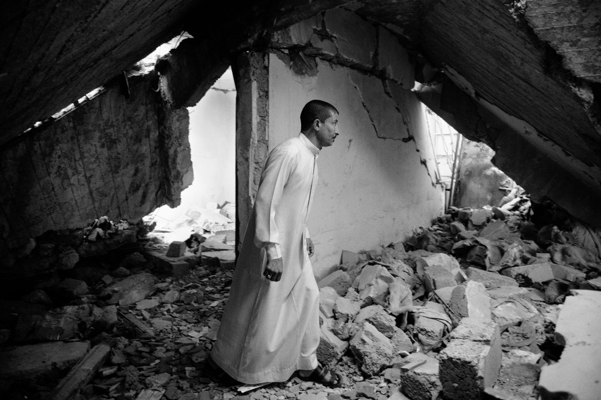 Iraq, Mosul. A man walks on the rubble of his house. During ISIS occupation, his place was used by Islamic State’s members because of its strategic position. The coalition heavily bombed it during the fight for Mosul.